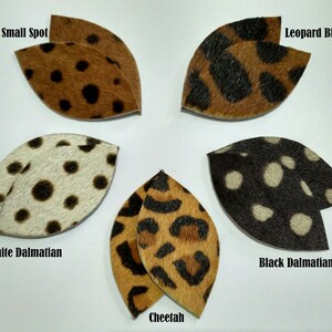 May include: Six different animal print fabric swatches in the shape of a leaf. The swatches are labeled "Leopard Small Spot", "Leopard Big Spot", "White Dalmatian", "Black Dalmatian", "Cheetah", and "Leopard Small Spot".