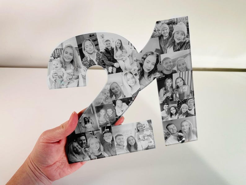 May include: Black and white photo collage of the number 21, made up of individual photos of people. The photos are arranged in a mosaic pattern to form the number.