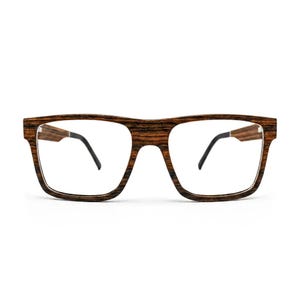 May include: Spectacles featuring a rectangular frame with a dark brown and black wood grain pattern. The frame has a thick bridge and wide rims, complemented by thin black temple arms that extend from the sides of the wooden front piece.