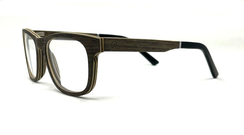 May include: Eyeglasses with a layered wood-grain frame featuring a dark brown and tan striped pattern. The temples are made of the same wood material, transitioning to solid black tips. A small leaf icon is engraved on the outer temple.