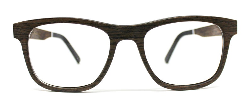 May include: Eyeglasses with a dark brown wood grain frame and clear lenses. The frame features a rectangular shape with rounded edges and thin black temple arms that connect to the wooden front with a small silver-colored metal hinge detail.