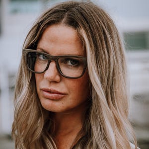 May include: Rectangular eyeglasses featuring a dark brown wood grain frame with a matte finish. The glasses have a thick bridge and wide temples, showcasing a natural textured wood pattern throughout the entire frame structure and dark lenses.