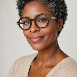 May include: Round eyeglasses featuring a dark brown wood-grain textured frame with a distinct horizontal striped pattern. The glasses have thin, light-colored temple arms and small metallic rivets on the front corners of the circular rims.