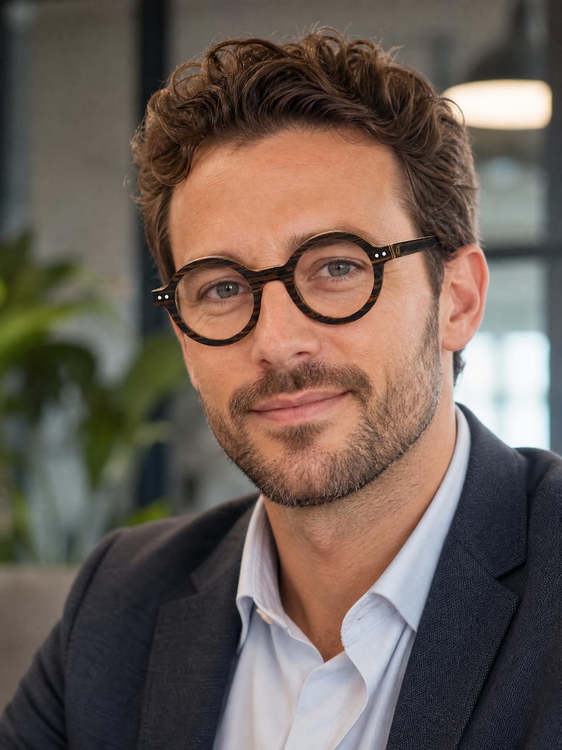 May include: Round eyeglasses with a dark brown and black wood-grain patterned frame. The glasses feature thin circular rims, a straight bridge, and small silver-toned metal rivets on the outer corners of the frame front, providing a distinct look.