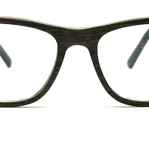 May include: Eyeglasses featuring a dark brown frame with a visible wood grain texture. The frame has a classic rectangular shape with rounded edges, clear lenses, and dark brown temples that extend from the sides of the front frame piece.