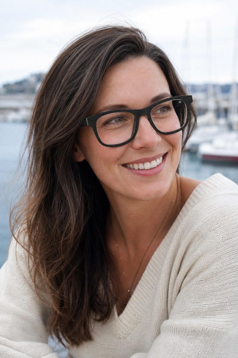 May include: Black rectangular eyeglasses with a thick frame and clear lenses. The frames feature a matte finish and a simple, structured design that sits across the bridge of the nose. The glasses have a classic shape with slightly rounded corners.
