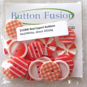 May include: A package of red and white buttons with various designs, including stripes and gingham patterns. The package includes the text "Button Fusion" and "2118W Red Capert Buttons".