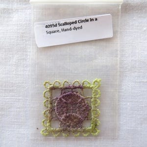 May include: A hand-dyed, square-shaped lace doily with a scalloped edge and a circular design in the center. The doily is in a clear plastic bag with a label that reads "4095d Scalloped Circle in a Square, Hand-dyed."