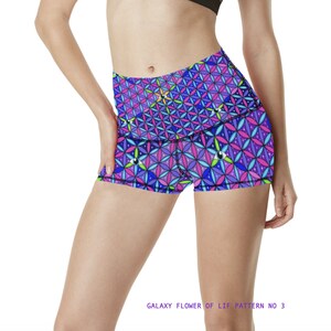 May include: A pair of athletic shorts with a colorful geometric pattern featuring a flower of life design. The shorts are purple, pink, blue, and green with a black waistband. The text "GALAXY FLOWER OF LIF PATTERN NO 3" is printed below the image.