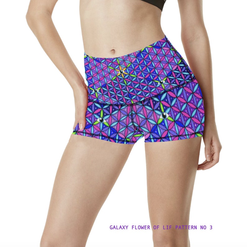 May include: A pair of athletic shorts with a colorful geometric pattern featuring a flower of life design. The shorts are purple, pink, blue, and green with a black waistband. The text "GALAXY FLOWER OF LIF PATTERN NO 3" is printed below the image.