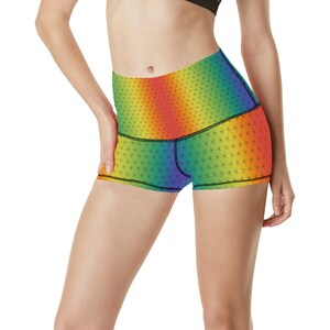 May include: Rainbow high-waisted athletic shorts with a geometric pattern. The shorts have a black waistband and a black trim around the leg openings.