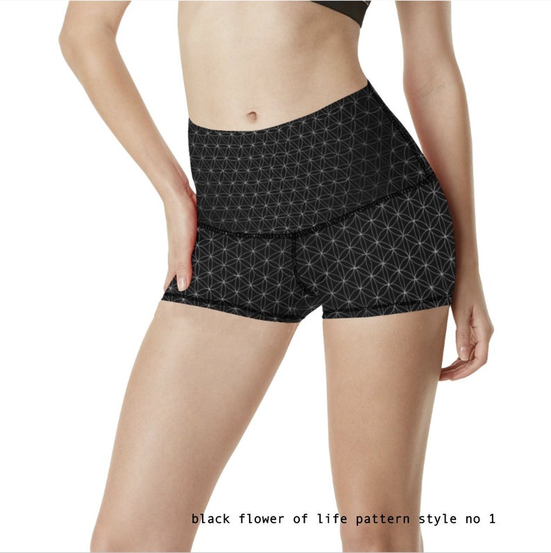 May include: Black athletic shorts with a geometric pattern. The pattern is a white flower of life design on a black background. The shorts have a high waist and a comfortable fit.