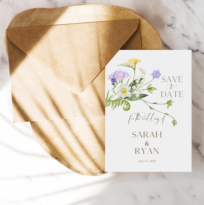 May include: Save the date card with a floral design featuring purple, white, and yellow flowers. The text reads "Save the Date for the wedding of Sarah & Ryan July 12, 2025".