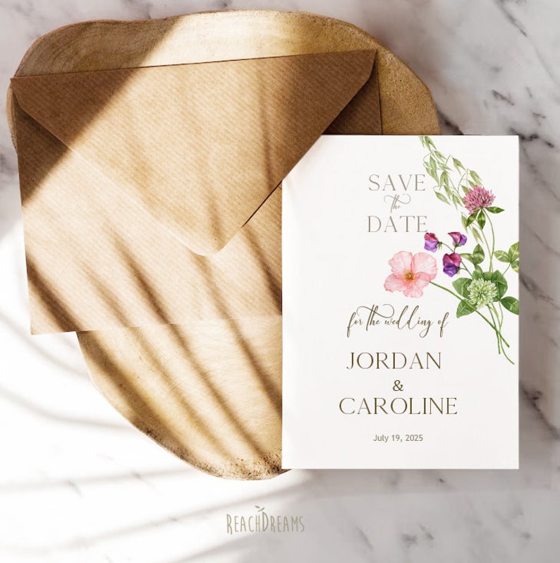 May include: Save the date card with floral illustrations. The card says "Save the Date for the wedding of Jordan & Caroline, July 19, 2025".