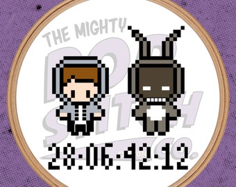 May include: Embroidered hoop art featuring a pixelated design of a person with a grey hoodie and a rabbit-like creature with brown fur. The text "The Mighty Stitch" and "28:06:42:12" are also included in the design.