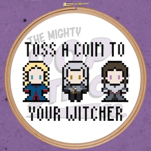 May include: Embroidered hoop art featuring three pixelated characters with the text "The Mighty Toss A Coin To Your Witcher".