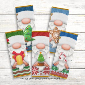 May include: Set of six Christmas gnome chocolate bar wrappers. Each wrapper features a different gnome design with a Christmas-themed item, such as a Christmas tree, a candy cane, a gingerbread cookie, a gift box, a snow globe, and a present. The wrappers are printed on a white background with a gold border.