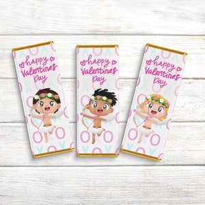 May include: Three chocolate bar wrappers with a white background and pink and blue accents. Each wrapper features a cartoon cupid with wings, a bow and arrow, and a flower crown. The text "happy valentines day" is printed on each wrapper.