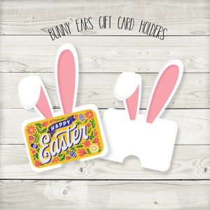May include: Two bunny ear gift card holders. One holder has a yellow card with the text "Happy Easter" in colorful letters and floral designs. The other holder is blank.