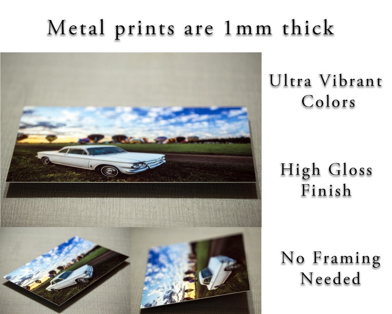 May include: A white vintage car with a blue sky and hot air balloons in the background. The car is on a metal print with a high gloss finish. The print is 1 mm thick and has ultra vibrant colors. No framing is needed.