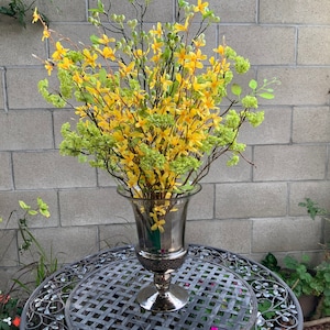 Faux Silk wood Like Branches with Green Flowers, Tall Branches With Gold Flowers And Wood Branches In A Smoke Gray Clear Vase