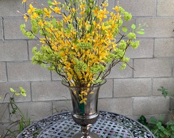 Faux Silk wood Like Branches with Green Flowers, Tall Branches With Gold Flowers And Wood Branches In A Smoke Gray Clear Vase