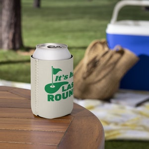 May include: White foam can cooler with a green golf course and flag graphic. The text reads "It's the last round".