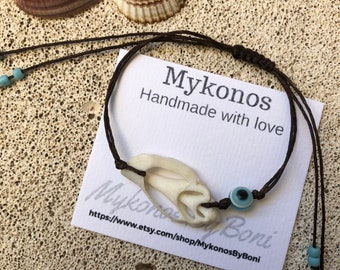 Mykonos sea shell bracelet with dark brown waxed cotton cord .