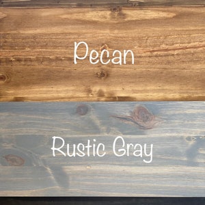May include: Four wood samples stained in different colors: dark walnut, pecan, rustic gray, and charcoal.