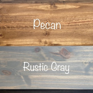 May include: Four wood samples stained in different colors: dark walnut, pecan, rustic gray, and charcoal.