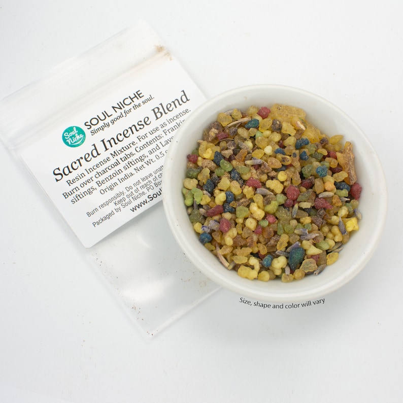 May include: A white ceramic bowl filled with a colorful blend of sacred incense. The incense is a mixture of resins, herbs, and spices. The bowl is sitting on a white surface. The text on the packaging reads "Soul Niche Simply good for the soul. Sacred Incense Blend Resin Incense Mixture. For use as incense. Burn over charcoal tabs. Contents: Frankincense, Benzoin siftings, and Lavender. Origin India. Net Wt. 0.5 oz. Burn responsibly. Do not leave unattended. Keep out of reach of children. Packaged by Soul Niche, PO Box 1234, Anytown, CA 91234. www.SoulNiche.com".