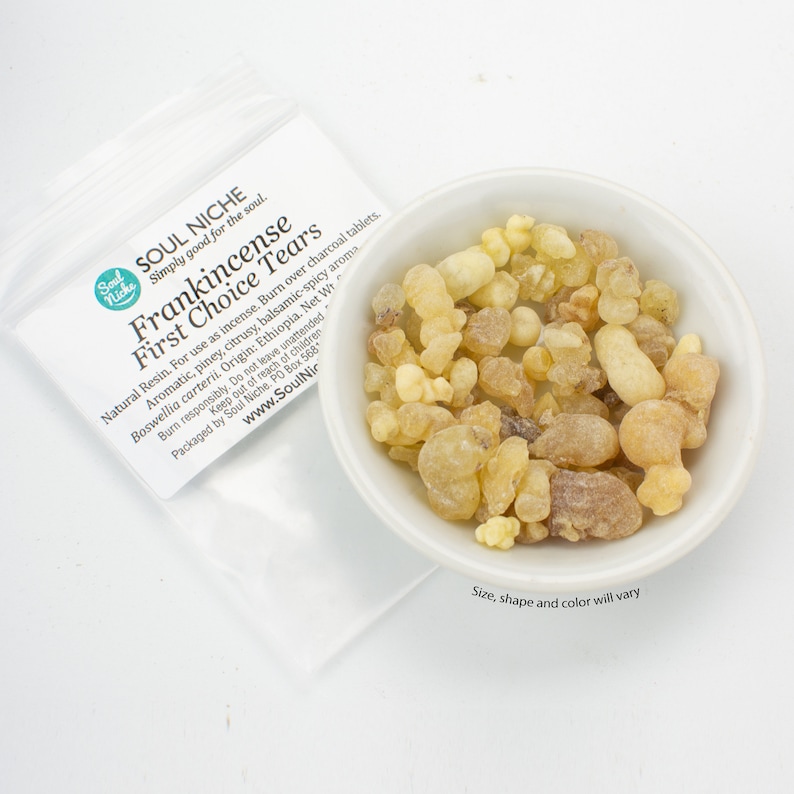 May include: A small white bowl filled with Frankincense First Choice Tears resin. The resin is a natural product and comes in various shapes and sizes. The resin is a light yellow color. The bowl is sitting on a white surface. The text on the bag reads "Soul Niche Simply good for the soul. Frankincense First Choice Tears Natural Resin. For use as incense. Burn over charcoal tablets. Aromatic, piney, citrusy, balsamic-spicy aroma Boswellia carterii. Origin: Ethiopia. Net Wt Burn responsibly. Do not leave unattended. Packaged by Soul Niche. PO Box 568 www.SoulNiche.com".