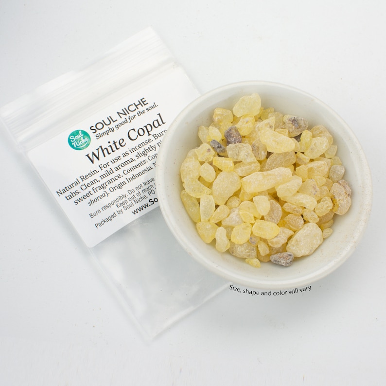 May include: A small white bowl filled with yellow and brown white copal resin pieces. The bowl is sitting on a white surface. The text on the bag reads "Soul Niche Simply good for the soul. White Copal Natural Resin. For use as incense. Burn tabs. Clean, mild aroma, slightly resinous sweet fragrance. Contents: Copal (Shorea). Origin Indonesia.  Burn responsibly. Do not leave unattended. Keep out of reach of children. Packaged by Soul Niche. PO Box 1101,  www.SoulNiche.com"