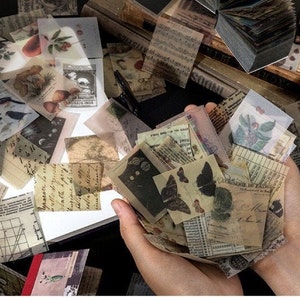 May include: A collection of vintage-style ephemera, including small, translucent paper squares with botanical illustrations, butterflies, and handwritten text. The papers are in various sizes and shapes, with a warm, aged color palette.