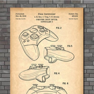 May include: An aged paper print of an Xbox controller patent. The print shows detailed diagrams of the controller from different angles, with labels and technical drawings. The text "Xbox Controller" and other technical details are visible.