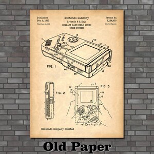 May include: A black and white line drawing of a Nintendo Gameboy patent. The patent is titled "Nintendo Gameboy" and includes the text "S. Okada & S. Kojo" and "COMPACT HAND-HELD VIDEO GAME SYSTEM". The patent number is 5,184,830. The drawing shows a side view of the Gameboy with various components labeled.