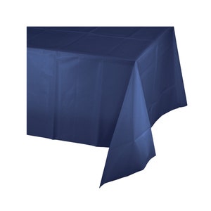 May include: A dark blue plastic tablecloth. The tablecloth is rectangular and has a smooth, flat surface.