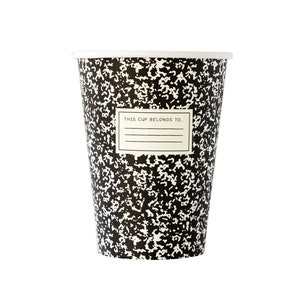 May include: A disposable paper cup with a black and white composition notebook design. The cup has a white rim and a label that reads "THIS CUP BELONGS TO...".