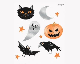 May include: A set of 24 Halloween temporary tattoos featuring black cats, ghosts, pumpkins, bats, crows, and stars. The tattoos are silver and black with orange accents. Package total: 24 tattoos.