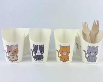 May include: Four white paper cups with a cat design. Each cup features a different colored cat with a white face. The cats are sitting and looking forward. The cups are on a white surface.