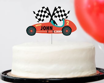 May include: Red race car cake topper with black and white checkered flags, the name "JOHN" and the number "2" on the side.