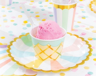 May include: A festive party scene with ice cream cups, plates, and straws. The cups have a waffle cone design and hold scoops of ice cream. Pastel-colored plates and cups are arranged on a table with confetti. A fun and colorful setting for a celebration.
