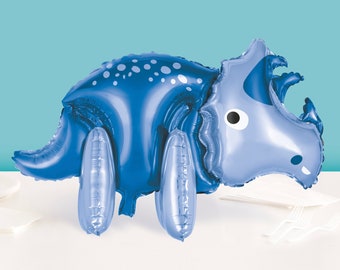 Puede incluir: Un globo de aluminio azul con forma de dinosaurio triceratops. El globo tiene manchas blancas y un ojo blanco.