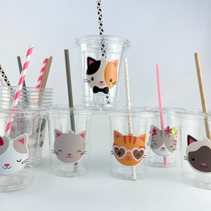 May include: Set of clear plastic cups with colourful straws and cat-themed stickers. The stickers feature different cat designs with various expressions and accessories.