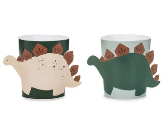 May include: Two paper cups with dinosaur designs. One cup features a green dinosaur with brown spikes, while the other cup has a beige dinosaur with brown spikes. Both cups have a green background.
