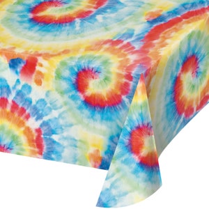 May include: A colorful tie-dye tablecloth with a swirling pattern in shades of blue, red, yellow, and green. The tablecloth is made of plastic and is perfect for parties or picnics.