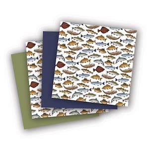 May include: Three sheets of wrapping paper with a pattern of various types of fish in shades of brown, gray, and red on a white background. The sheets are layered on top of each other, with the top sheet being a dark blue color.