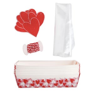 May include: A set of red heart-shaped paper cutouts, red and white baker's twine, a clear plastic bag, and a loaf pan with a pink and red heart pattern.