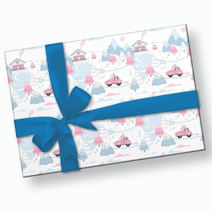 May include: A white gift wrap with a blue ribbon and bow. The wrapping paper features a repeating pattern of pink houses, blue mountains, and pink cars driving through a snowy winter landscape.