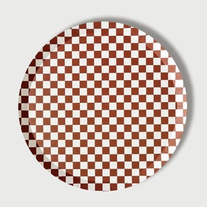 May include: A round paper plate with a brown and white checkered pattern.